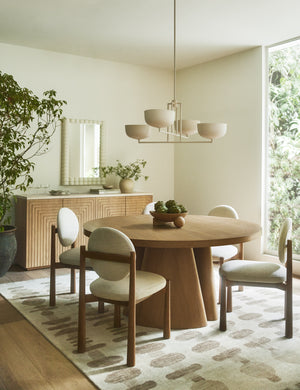 Dining room featuring the Keating round geometric wood pedestal dining table.