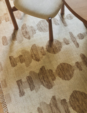 Yana hand-knotted organic pattern wool rug under a dining room chair.
