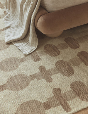 Yana hand-knotted organic pattern wool rug styled under a bed.