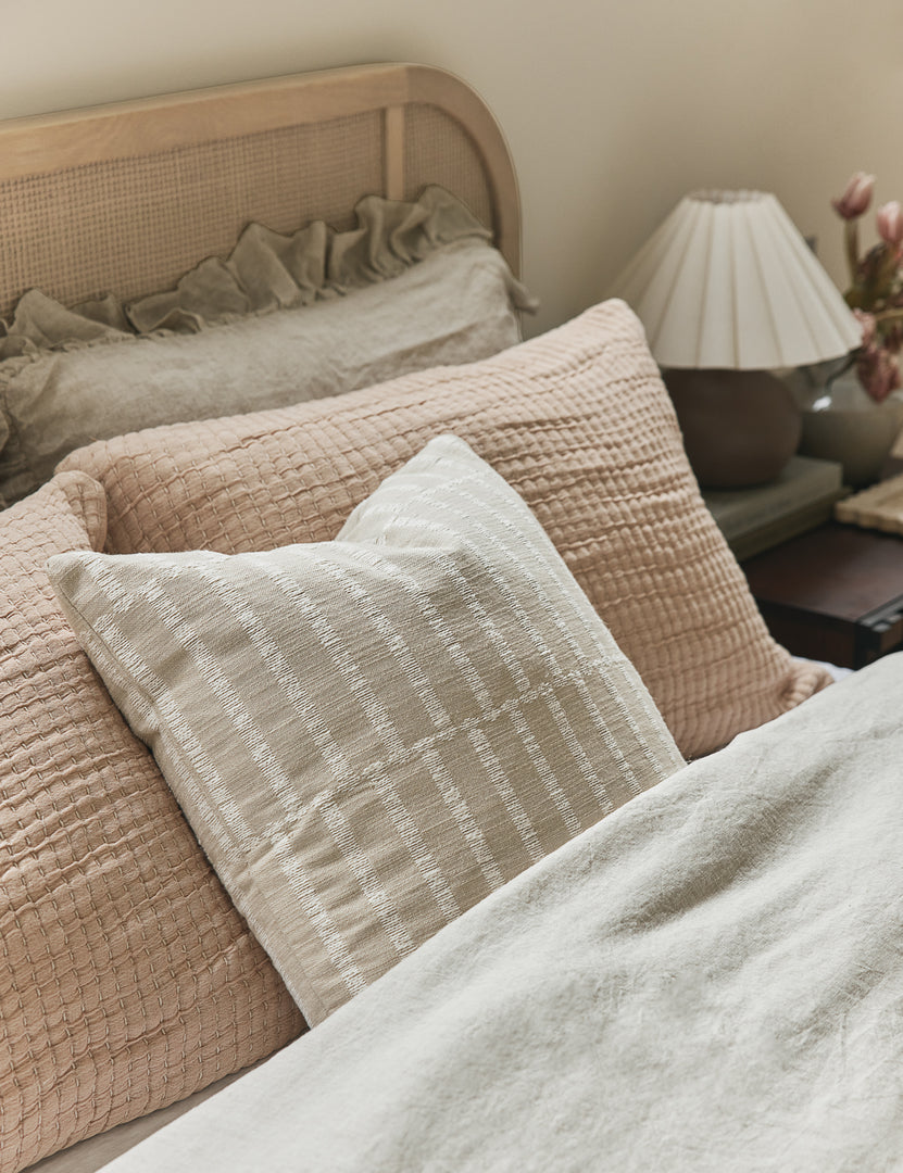 #color::ivory-and-natural #style::square | Thisbe offset stripe throw pillow styled on a bed.