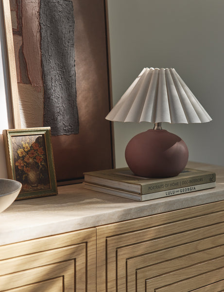 #size::mini #color::brick | Luis round ceramic mini table lamp styled on a sideboard.