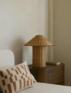 Terrene Woven Rattan Table Lamp by Elan Byrd styled on a bedside table.