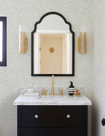 #color::blue | The Dainty Leaves floral Wallpaper by Rylee + Cru is in a bathroom with a black wooden marble topped sink and a black framed arched mirror