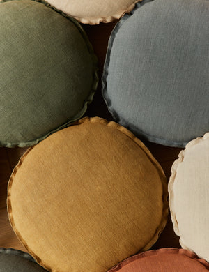 Various colors of the Arlo linen flange trim round pillow together.