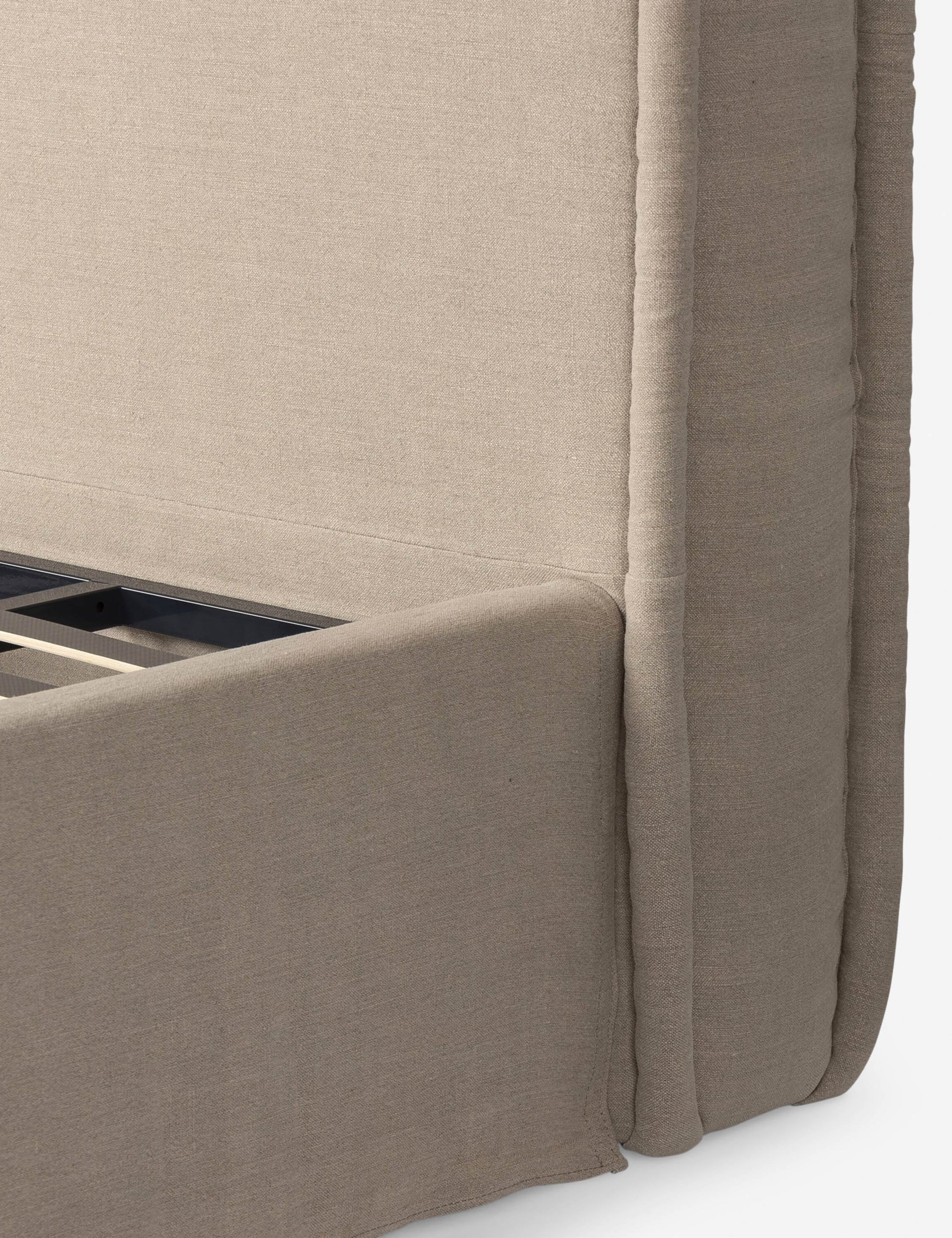 Detail shot of the upholstered bed frame and headboard corner.