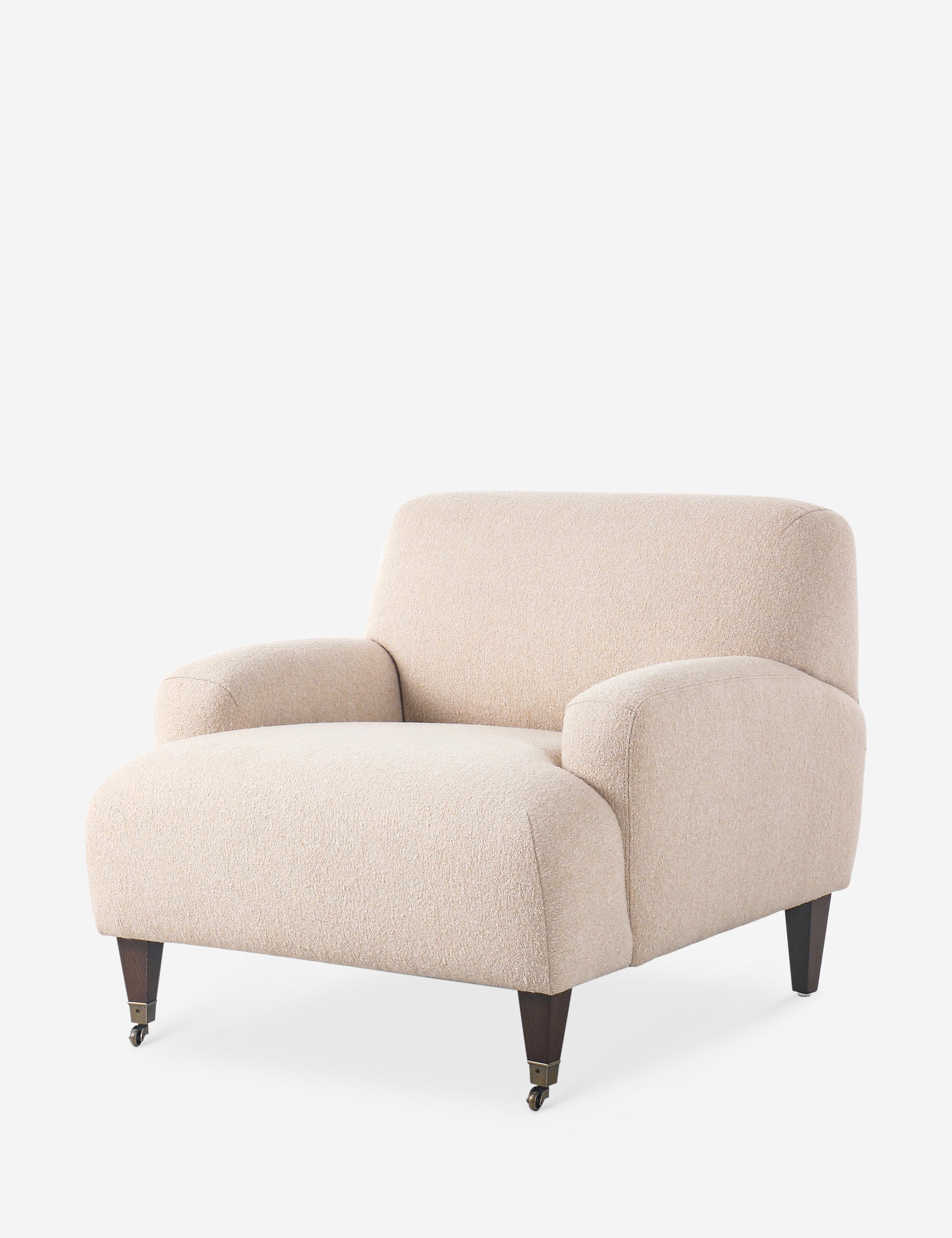 Dark olive-green velvet armchair from the side showing plump seat and armrests.