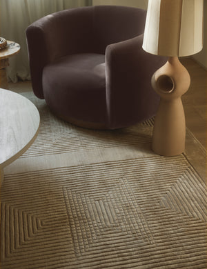 Halden handwoven carved design rug styled with a purple velvet accent chair and sculptural floor lamp.