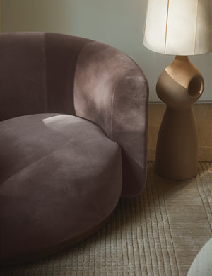 Lowry rounded silhouette velvet accent chair styled with a sculptural floor lamp.
