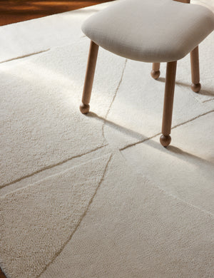 Close up view of the Malta Hi-Lo Pile Hand-Knotted Wool Rug by Aimee Song under a dining chair