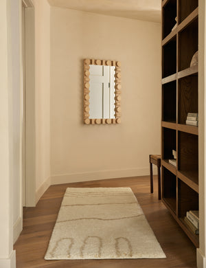 Currents Hand Knotted Wool Runner Rug by Elan Byrd styled in a hallway with a wall mirror.