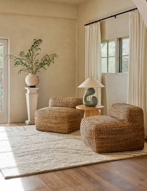 Saguaro Sculptural Ceramic Table Lamp by Elan Byrd styled on a round side table between two accent chairs.