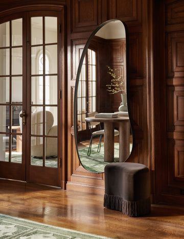 #color::pewter | Leganza slim frame organic silhouette full length mirror by Aimee Song hung on a wall styled next to a velvet accent stool
