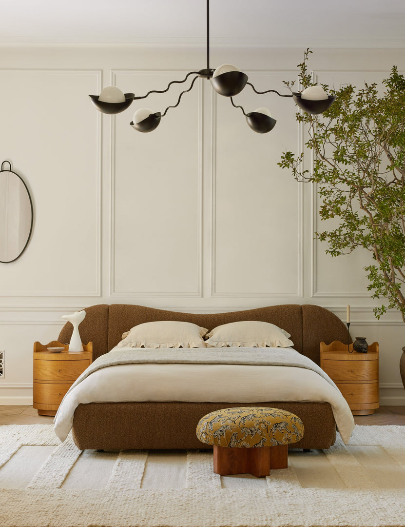 #color::bronze #size::62-dia | Kukka large modern wavy arm chandelier in bronze hanging in a bedroom over the bed
