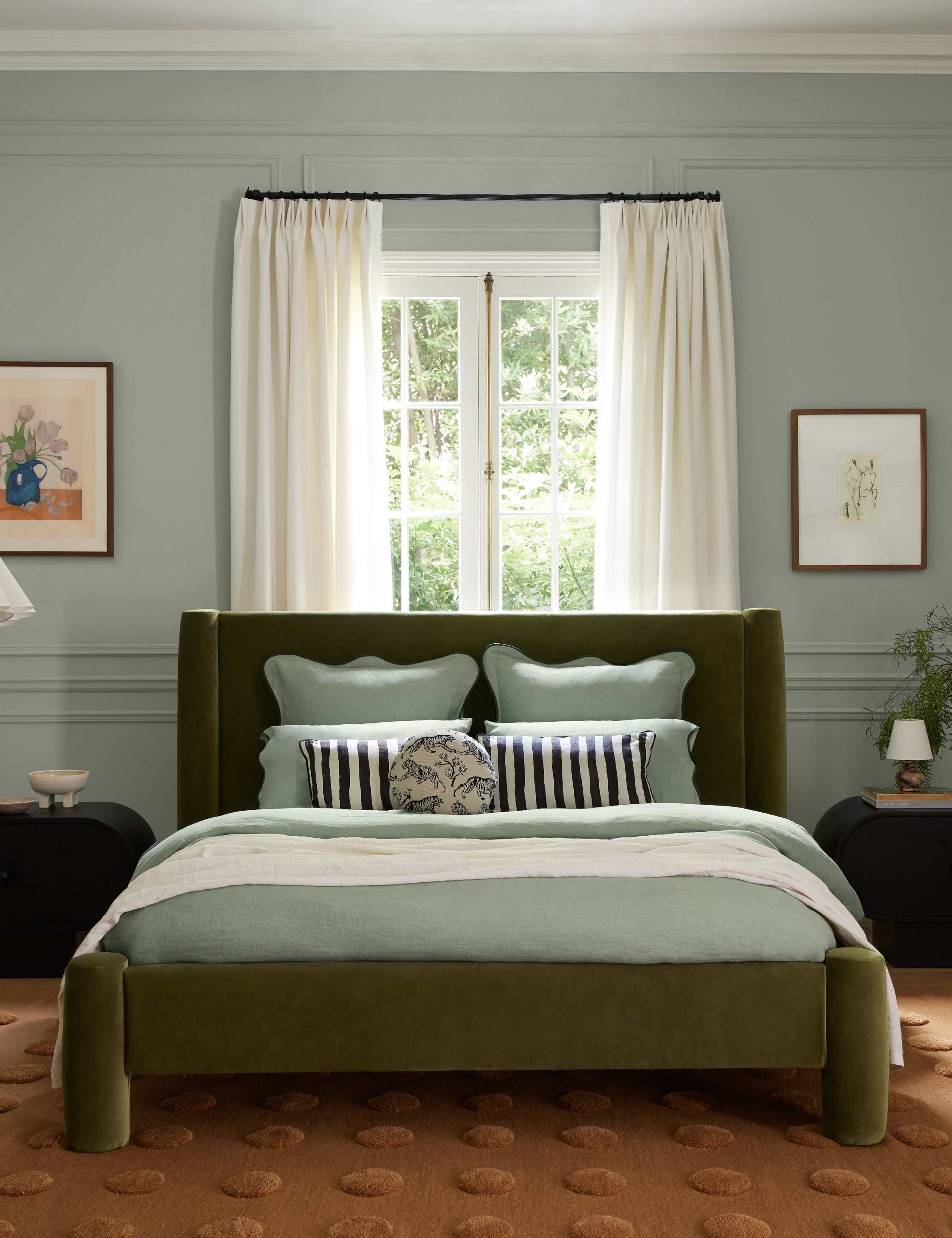 Light beige upholstered bed with rounded cylindrical posts at corners and white bedding.