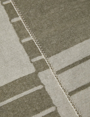 Close up view of the Checkered wool throw blanket in ivory and olive