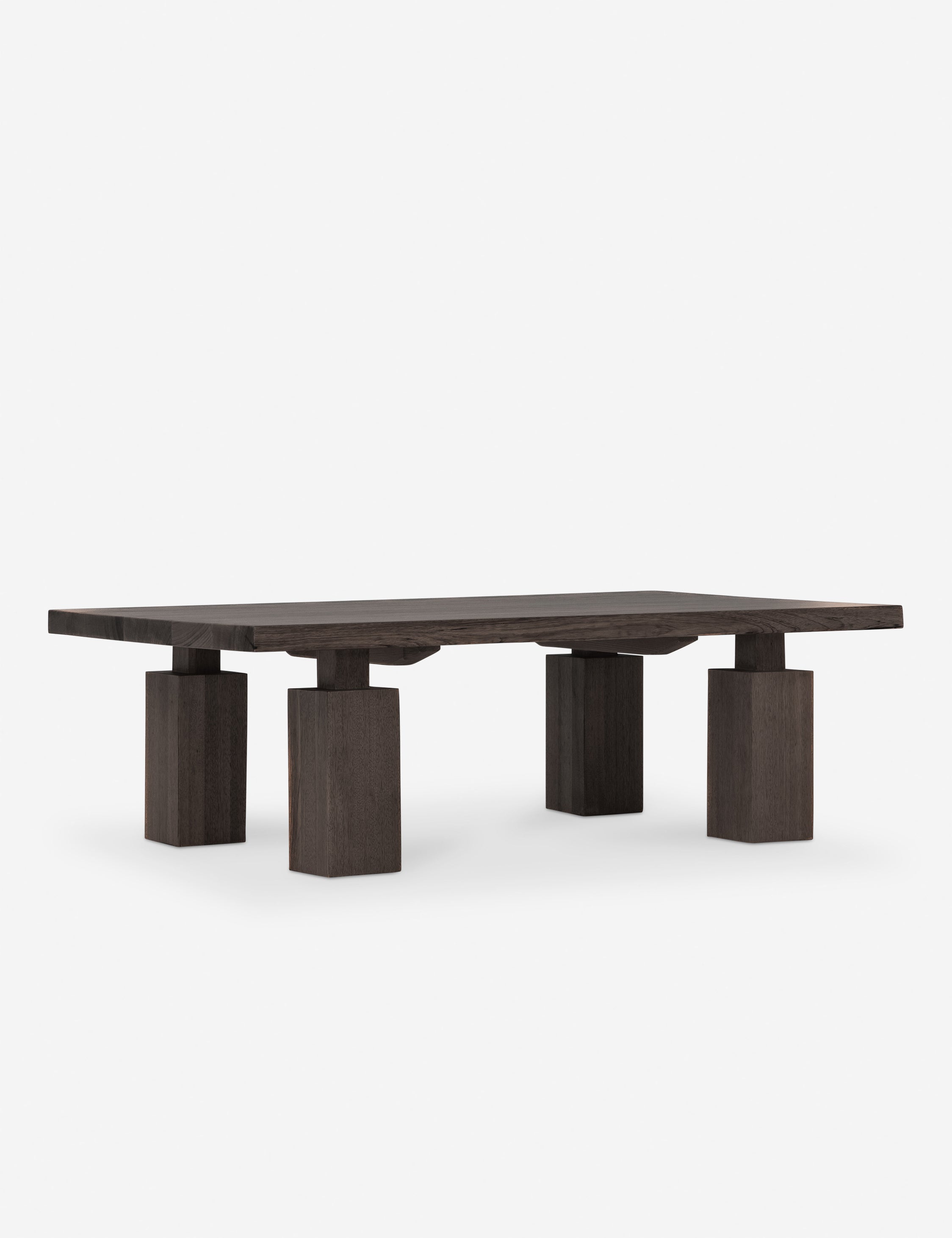 A solid dark wood coffee table with thick rectangular top and chunky square pedestal legs.