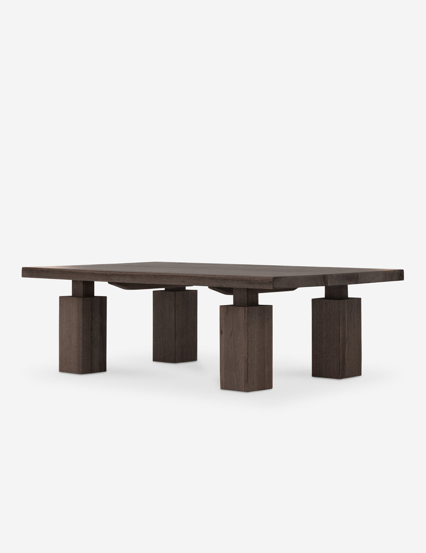 Another view of the wooden coffee table highlighting square legs and heavy construction.