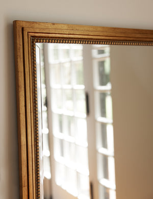 Top corner of the Corinne textural gold epoxy resin frame floor mirror.