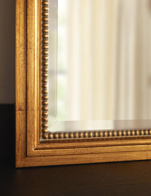 Bottom corner of the Corinne textural gold epoxy resin frame wall mirror.