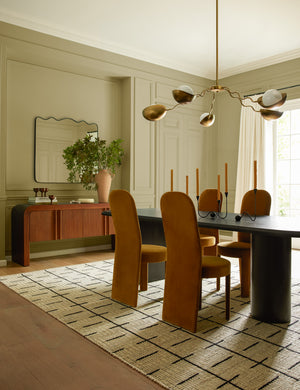 Four Halbrook upholstered tall back sculptural dining chairs in sienna velvet around a dining table
