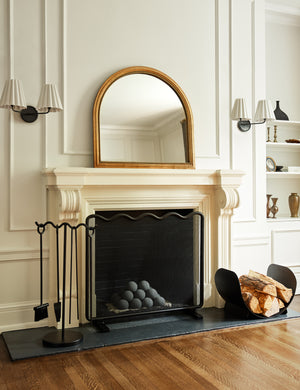 Corinne textural gold epoxy resin frame mantel mirror hanging above a fireplace.