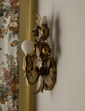 Angled side view of the Garda ornate floral metalwork wall sconce by Heidi Caillier