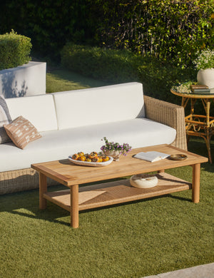 Gally teak and wicker outdoor coffee table and wicker outdoor sofa.