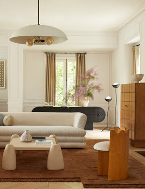 Koukero irregular shaped fringe wool area rug styled in a living room
