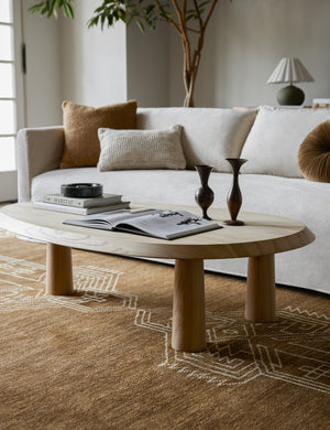 Living room featuring the Rodolfo organic oval natural wood coffee table and white sofa