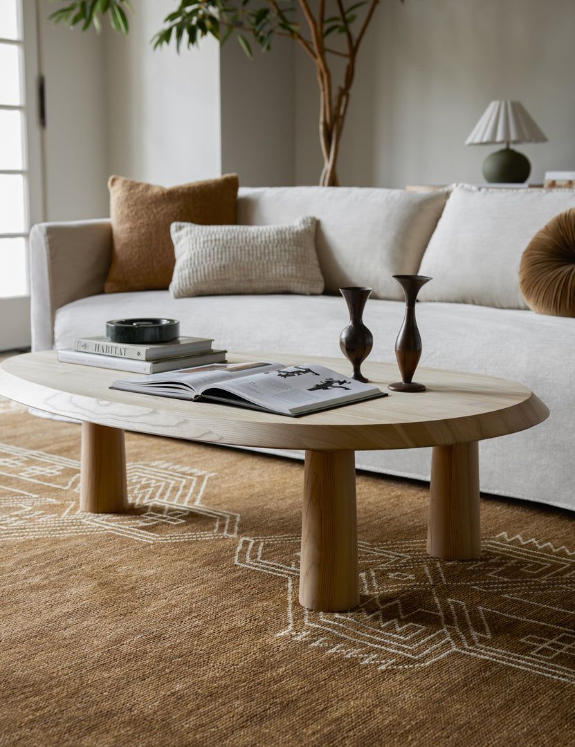| Living room featuring the Rodolfo organic oval natural wood coffee table and white sofa