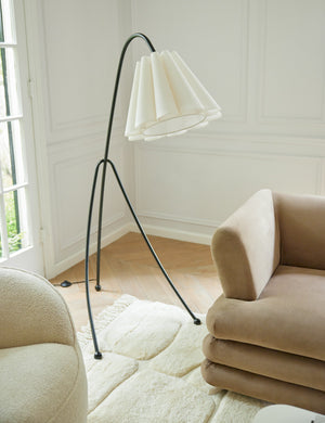 Addie modern fluted shade floor lamp styled next to a chair and sofa