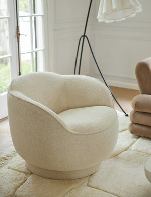 Fern scalloped back boucle upholstered swivel chair styled next to the Addie floor lamp