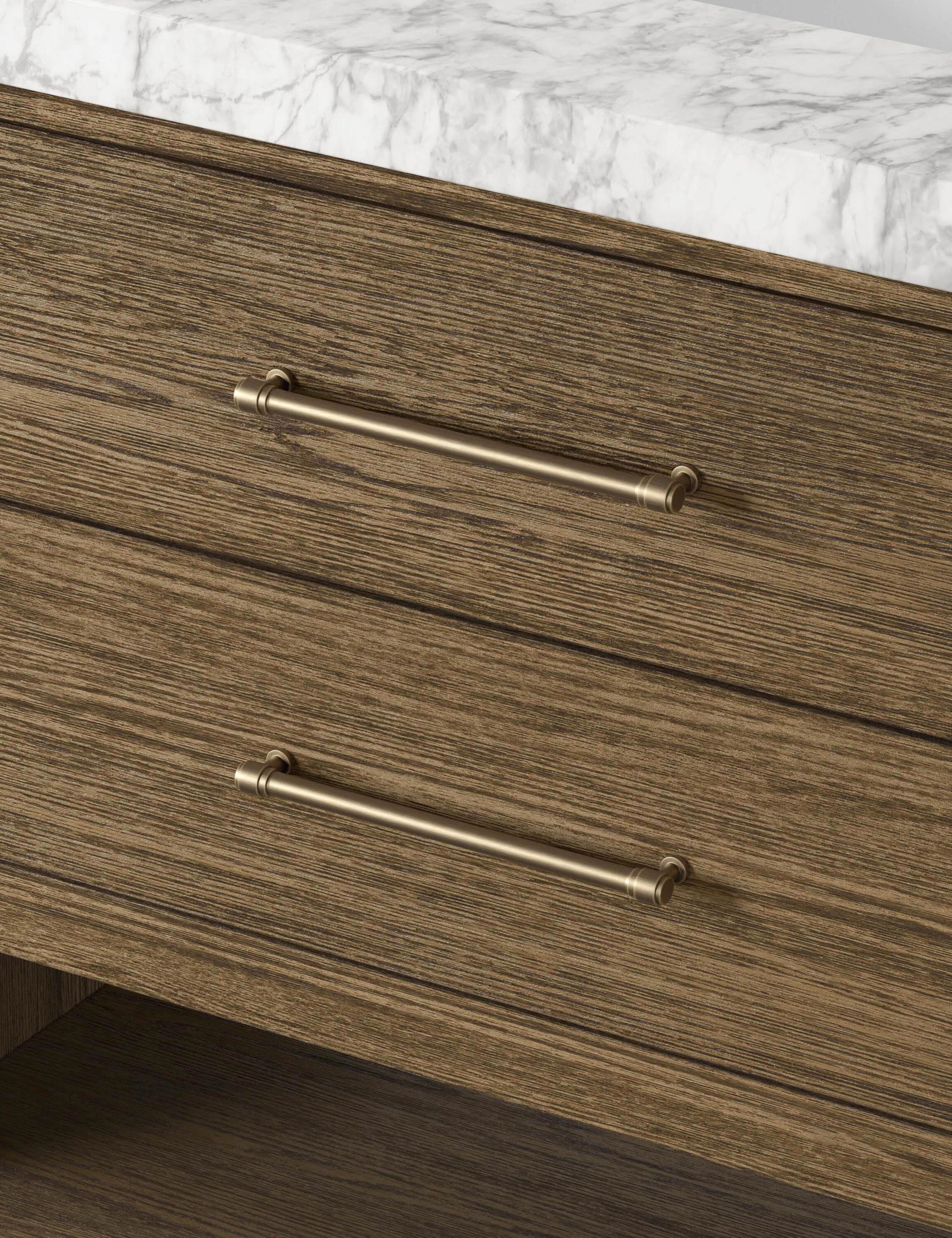 Close-up of the brass drawer pulls on the toasted oak vanity.