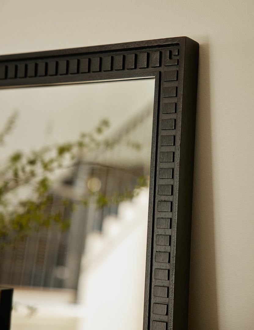 #color::black | Close up top corner view of the Thelma black carved wood framed mirror