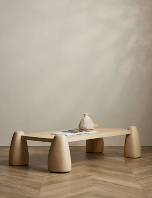 Quarry sculptural concrete coffee table styled with a coffee table book and vase