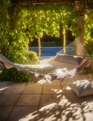 Levata Striped Hammock by Sarah Sherman Samuel hanging in a covered outdoor space.