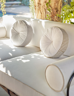 Littu Indoor / Outdoor Striped Disc Pillow by Sarah Sherman Samuel in Brown styled on an outdoor sofa.