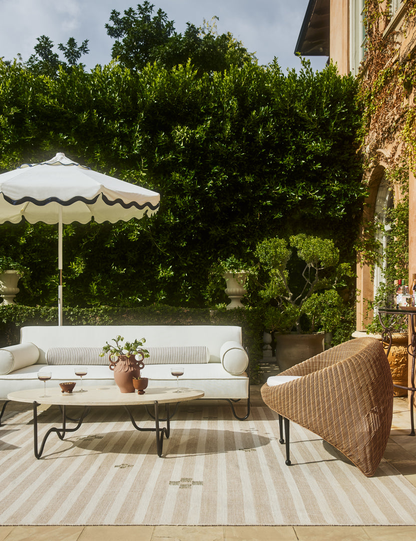 #color::ivory | Outdoor patio space featuring the Peggy sculptural iron frame and white cushion outdoor sofa.