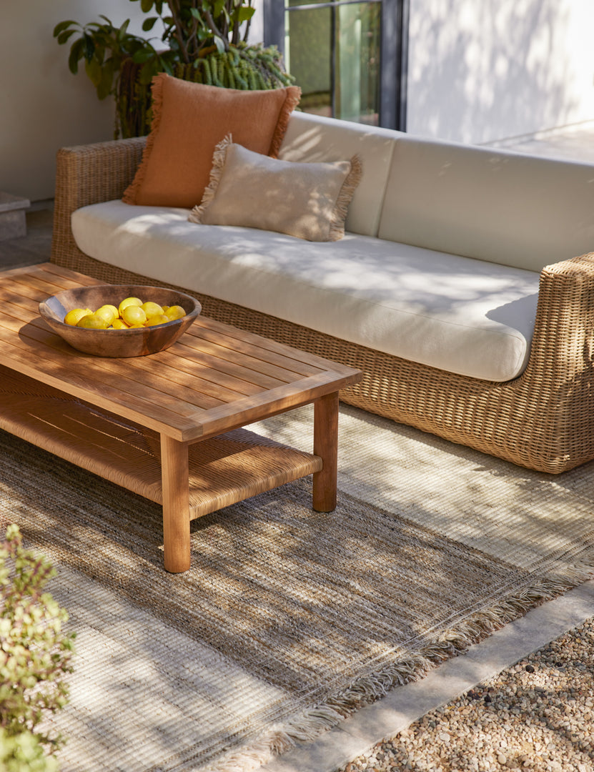 #color::natural | Gally teak and wicker outdoor coffee table and wicker outdoor sofa.