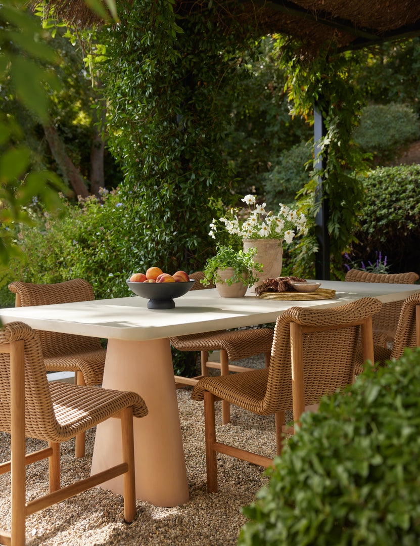 #color::natural | Six Gally wicker and teak outdoor dining chairs styled with a two-toned stone outdoor dining table.