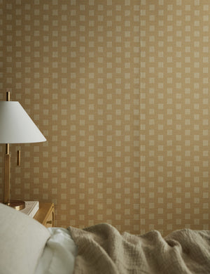 Sand Dune Grasscloth Wallpaper by Élan Byrd on a bedroom wall.