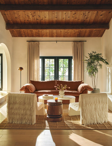 #color::espresso | Living room featuring the Coco round drum beaded wood side table by Carly Cushnie.