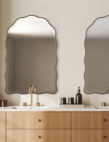#color::brass | Two Gannet scalloped frame wall mirror hanging above a bathroom vanity