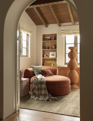 The Haldar chunky tasseled edge plaid throw draped over a chaise.