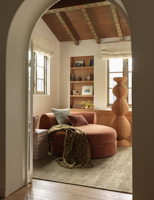 Fania lightweight linen-cotton blend floral motif throw draped over a chaise.