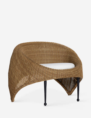Angled view of the Marisol sculptural wicker outdoor accent chair.