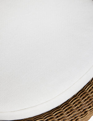 Close up of the cushion of the Marisol sculptural wicker outdoor accent chair.