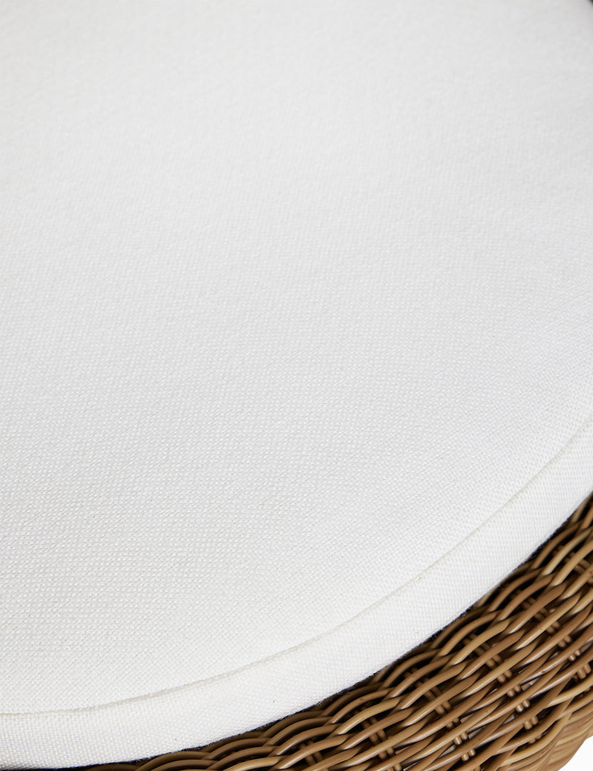 #color::natural | Close up of the cushion of the Marisol sculptural wicker outdoor accent chair.
