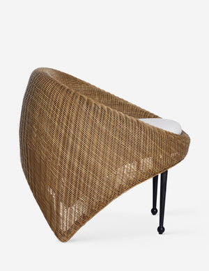 Side view of the Marisol sculptural wicker outdoor accent chair.
