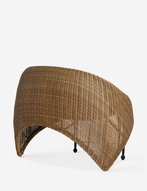 Angled back view of the Marisol sculptural wicker outdoor accent chair.